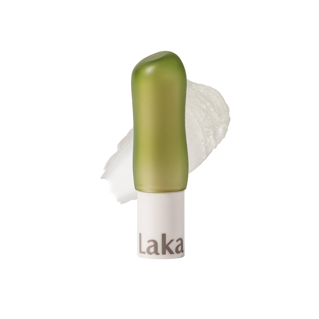 LAKA Soul Vegan Lip Balm #01 Clear is a nourishing, plant-based balm that delivers lasting hydration and a natural shine. Infused with Shea Butter, Sunflower Seed Oil, and Sweet Almond Extract, it softens and conditions your lips, while Hydrolyzed Hyaluronic Acid locks in moisture for a smooth, plump look. The lightweight, non-sticky formula includes refreshing citrus oils for a subtle, uplifting scent. Perfect for daily use to keep lips soft, hydrated, and healthy.